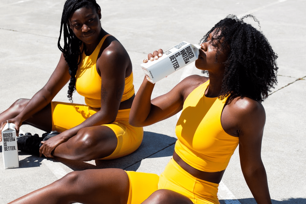 a woman drinking water after a workout