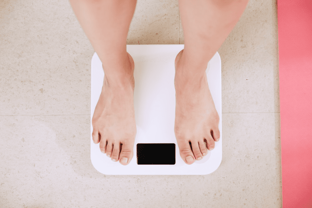person standing on a weighing machine